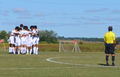 The team huddles before their game against Parkview Christian, which they would go on to win 7-0.