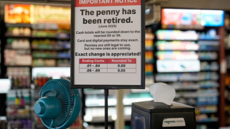 Sign displaying the new Kwik Trip policy to round down to the nearest nickel as a result of the penny shortage.